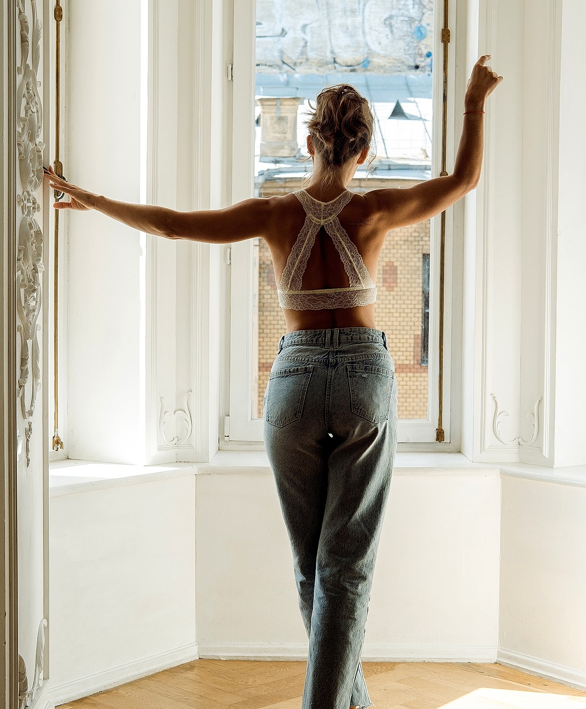 Woman in lace top by the window.