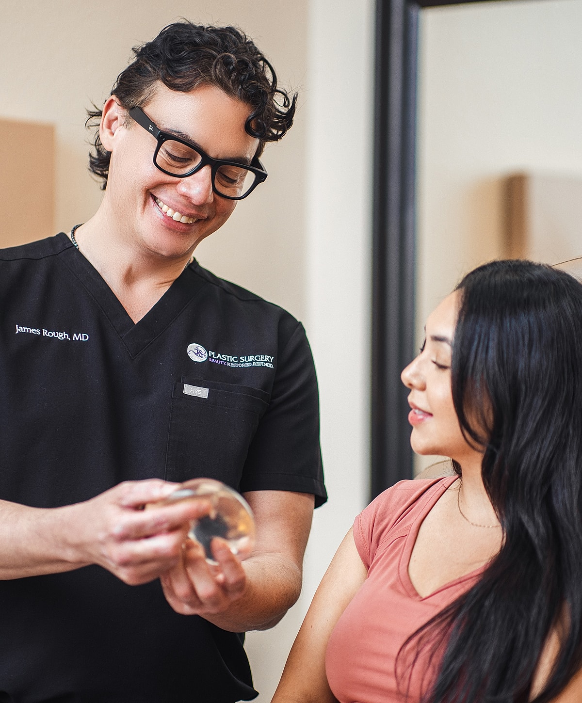 Consultation about cosmetic surgery options and implants.