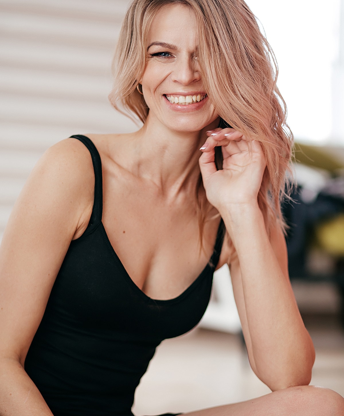 Smiling woman in a black top, candid portrait.