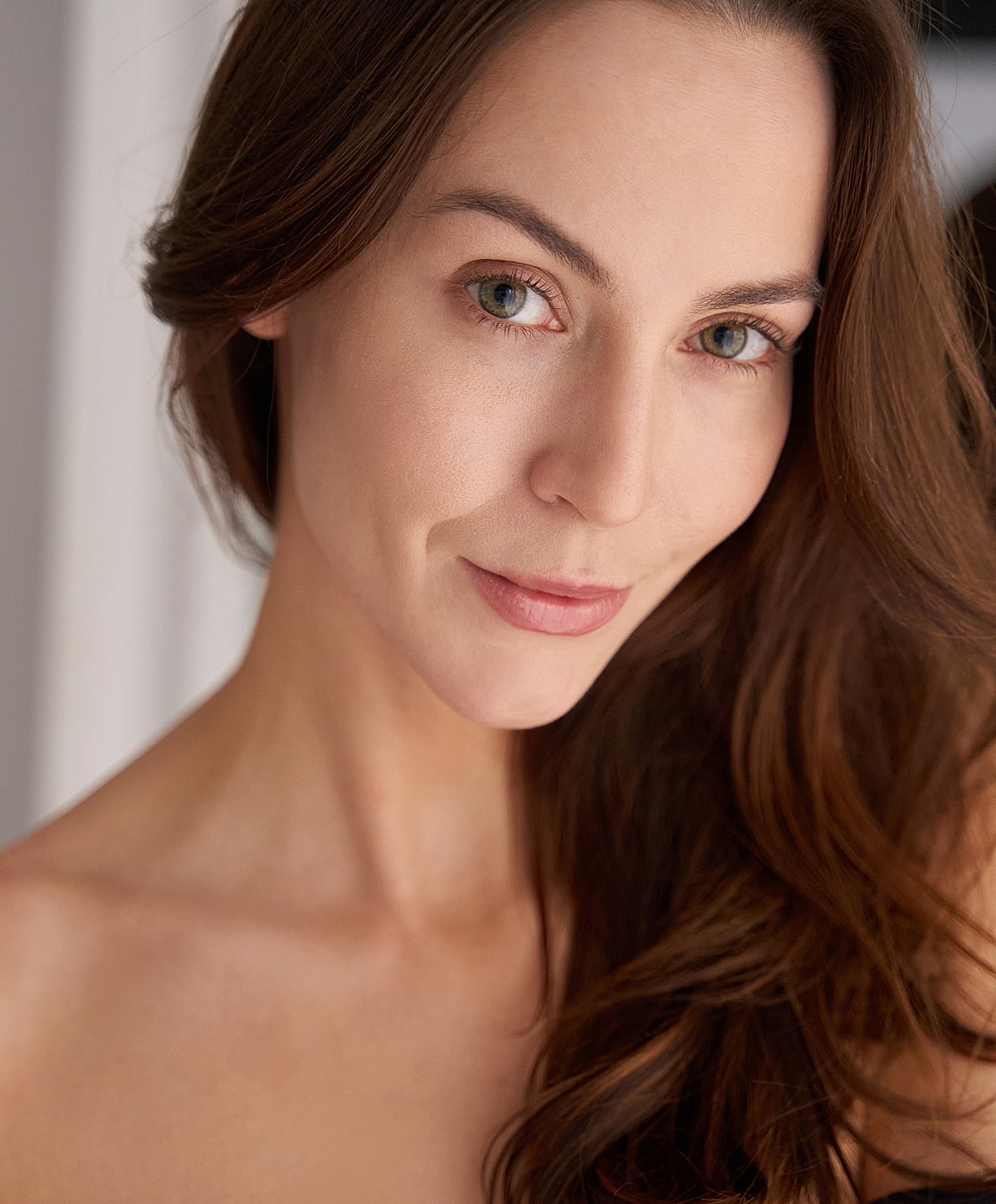 Portrait of a woman with long brown hair.