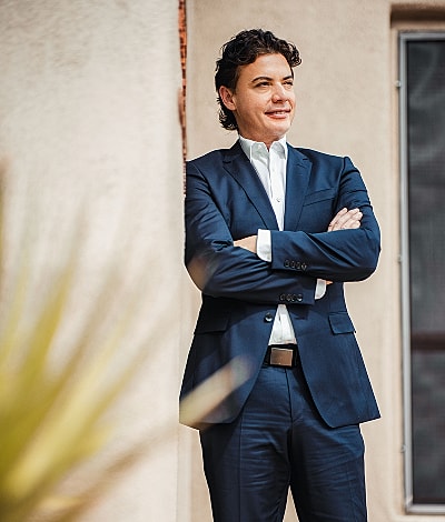 Businessman standing confidently in tailored suit.