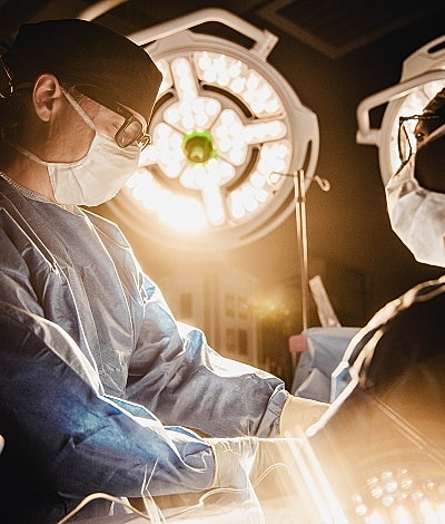 Surgeons performing a procedure in an operating room.