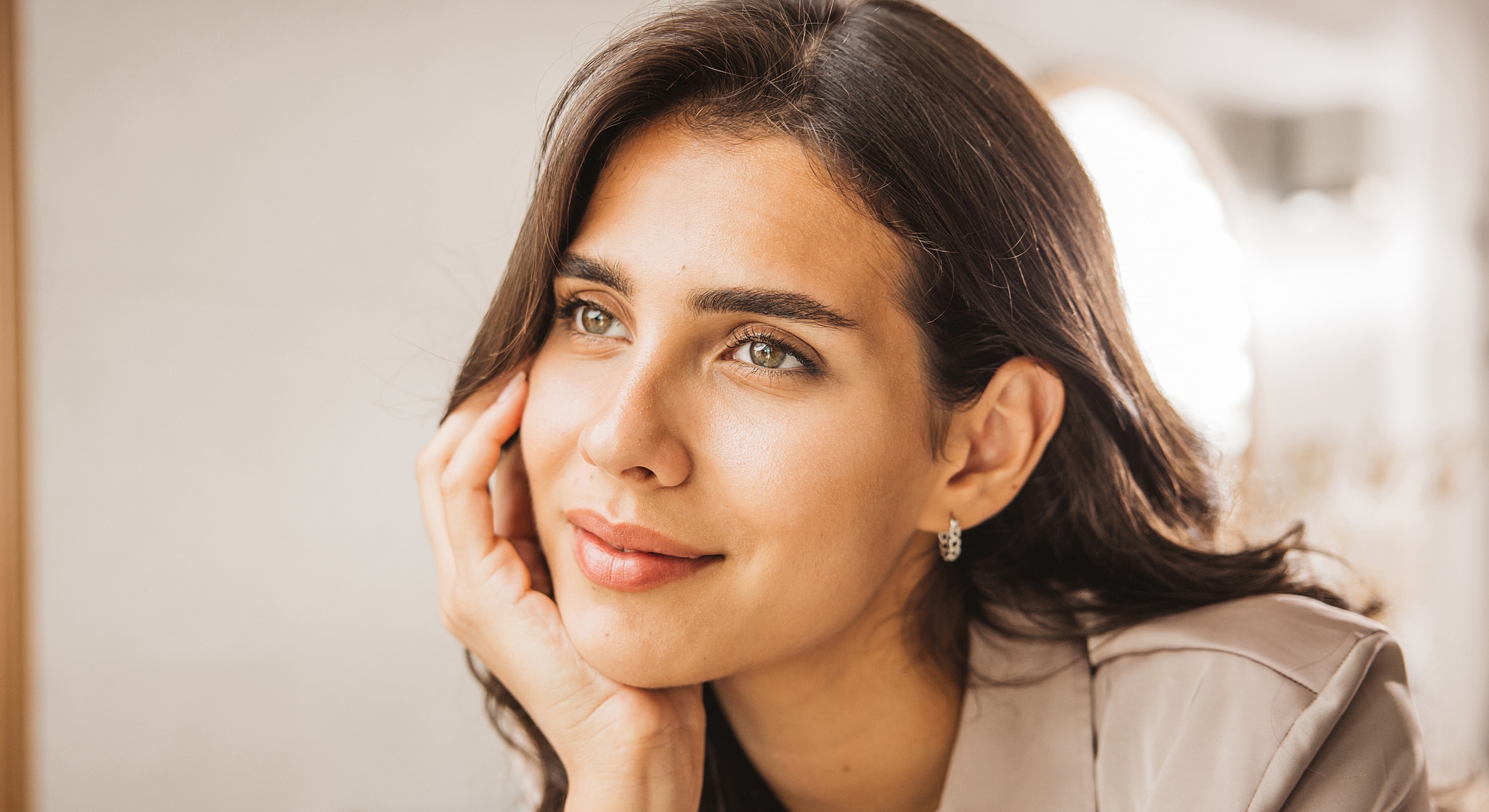 Woman thoughtfully resting her chin on her hand.